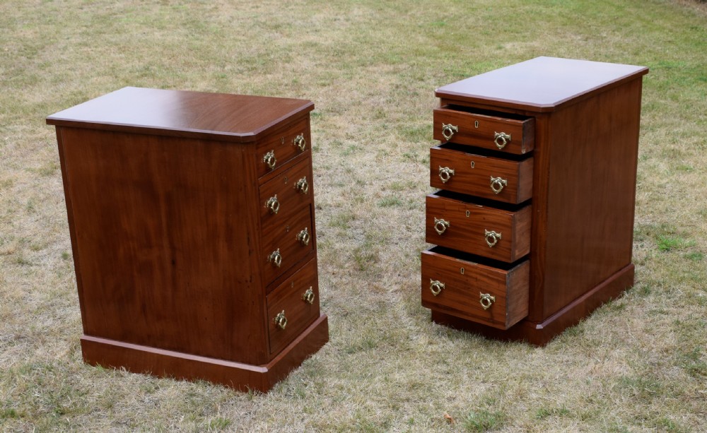 A pair of Victorian mahogany four-drawer bedside chests featuring brass ring handles, escutcheons, and plinth bases. View XIV
