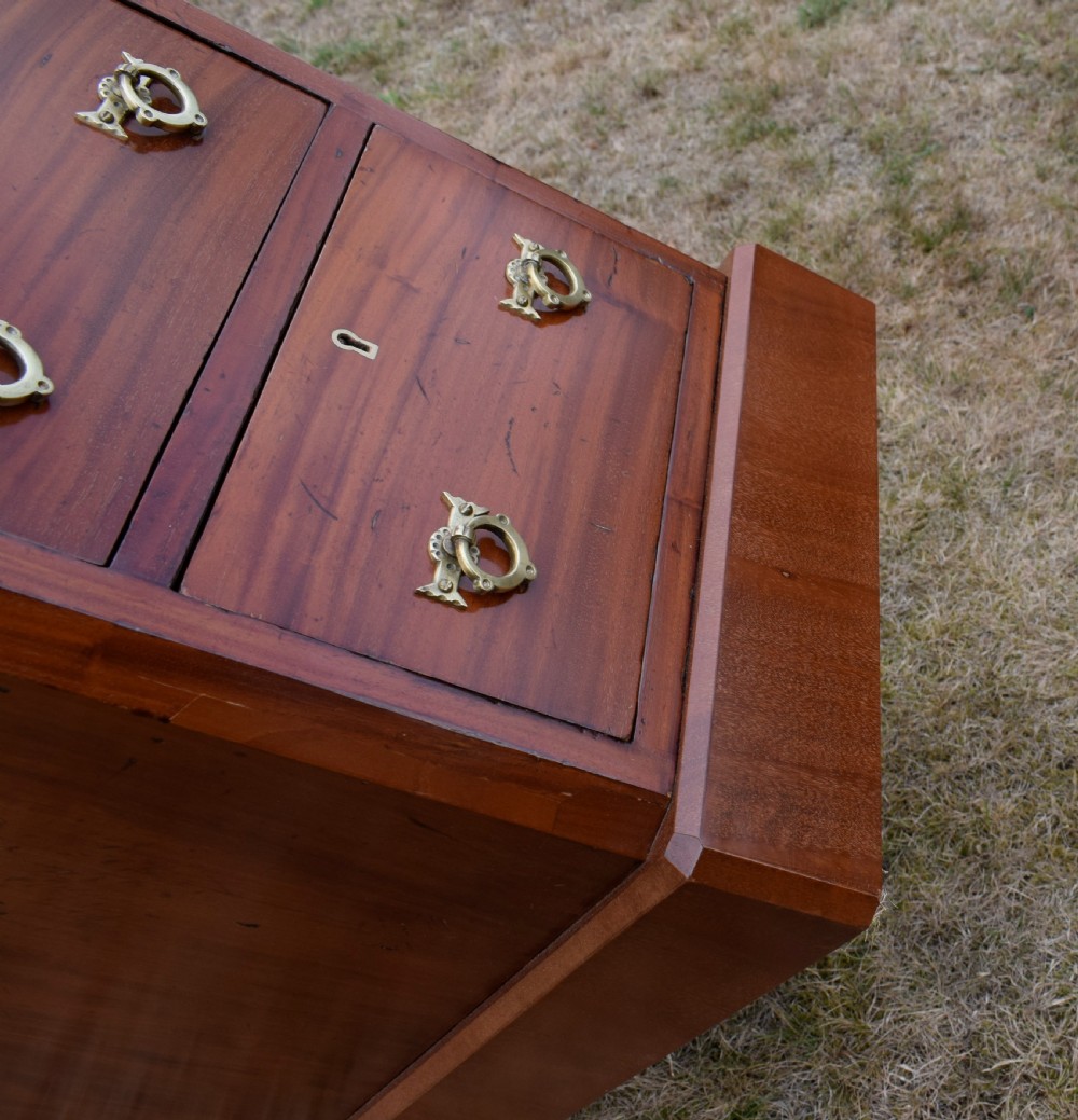 A pair of Victorian mahogany four-drawer bedside chests featuring brass ring handles, escutcheons, and plinth bases. View XVIII