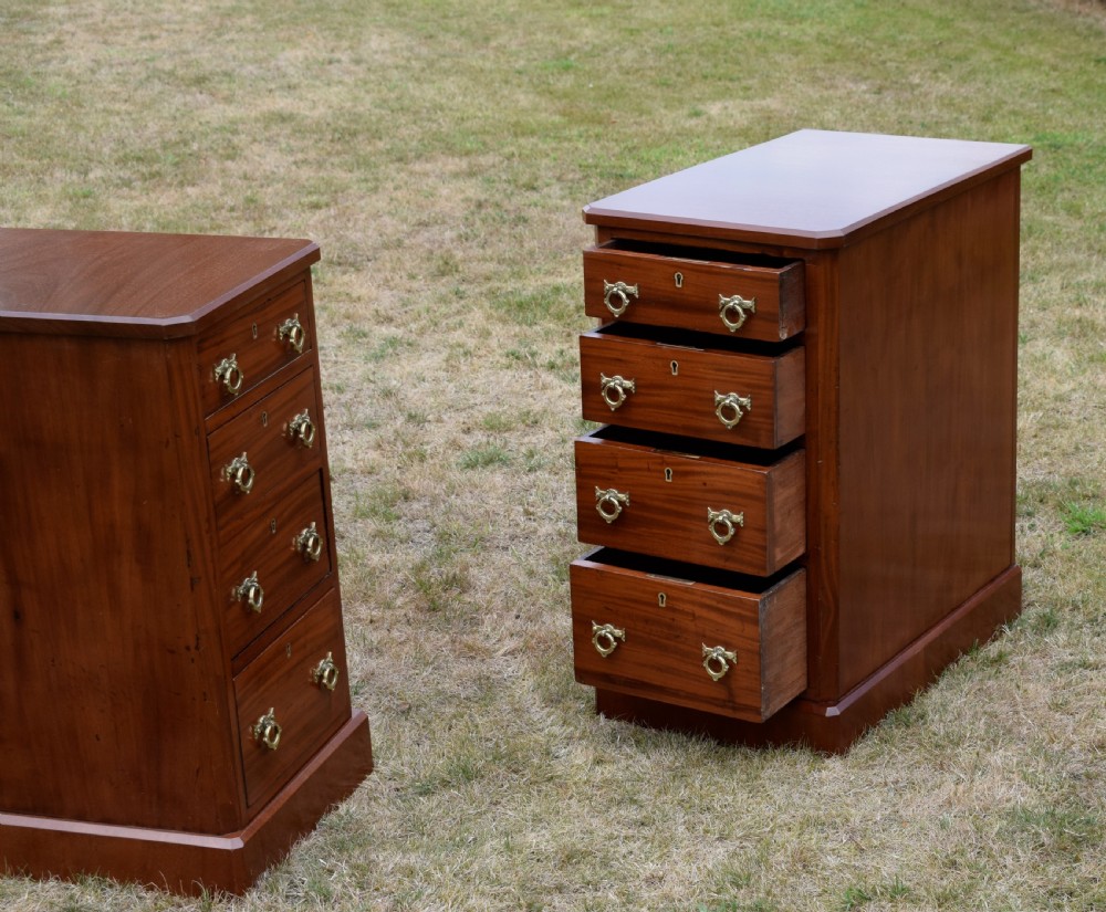 A pair of Victorian mahogany four-drawer bedside chests featuring brass ring handles, escutcheons, and plinth bases. View XIX