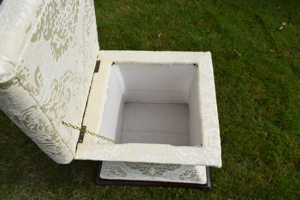 A square Regency storage ottoman with concave sides, upholstered in cream damask fabric and set upon a dark rosewood plinth base. View VI