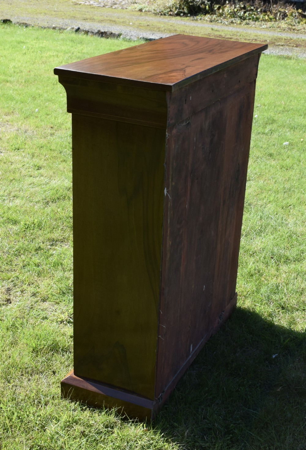A Victorian warm brown walnut display cabinet featuring a single glazed door, floral wood inlay on the top frieze, and decorative brass mounts. View XVI