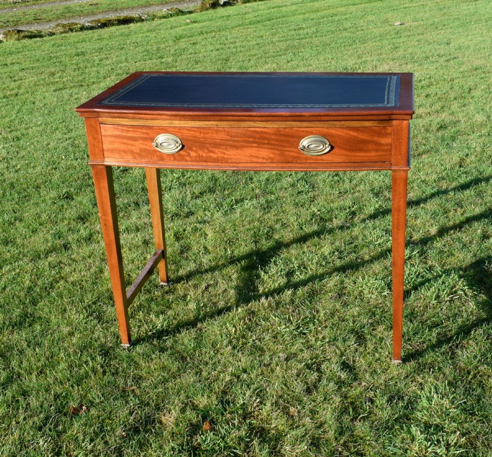 An early twentieth-century mahogany writing table featuring an inset green leather top, a single drawer with two brass oval drop handles, and tapered square legs. View III