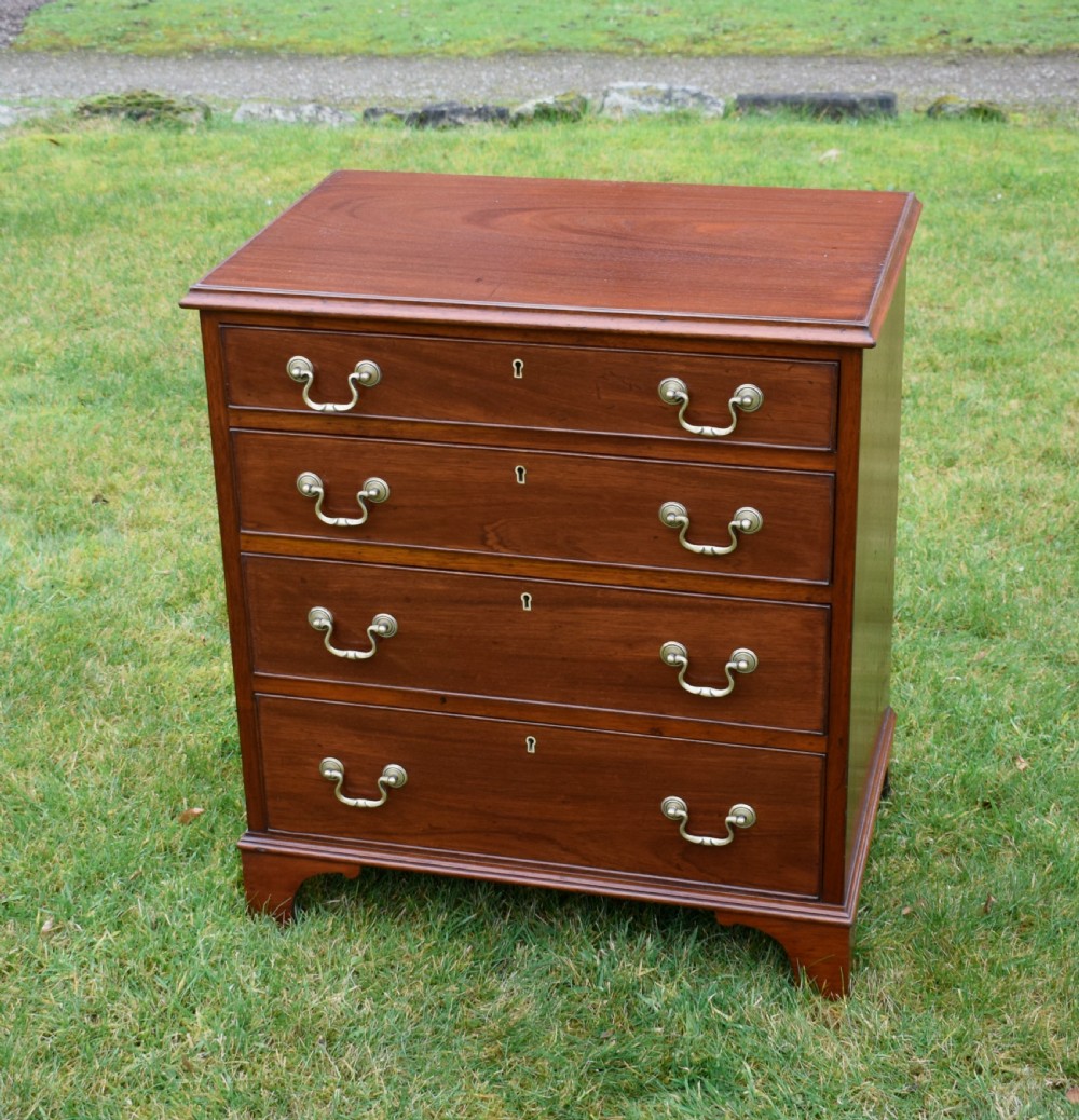 A mahogany chest of drawers featuring four graduated drawers with brass swan-neck handles and bracket feet.