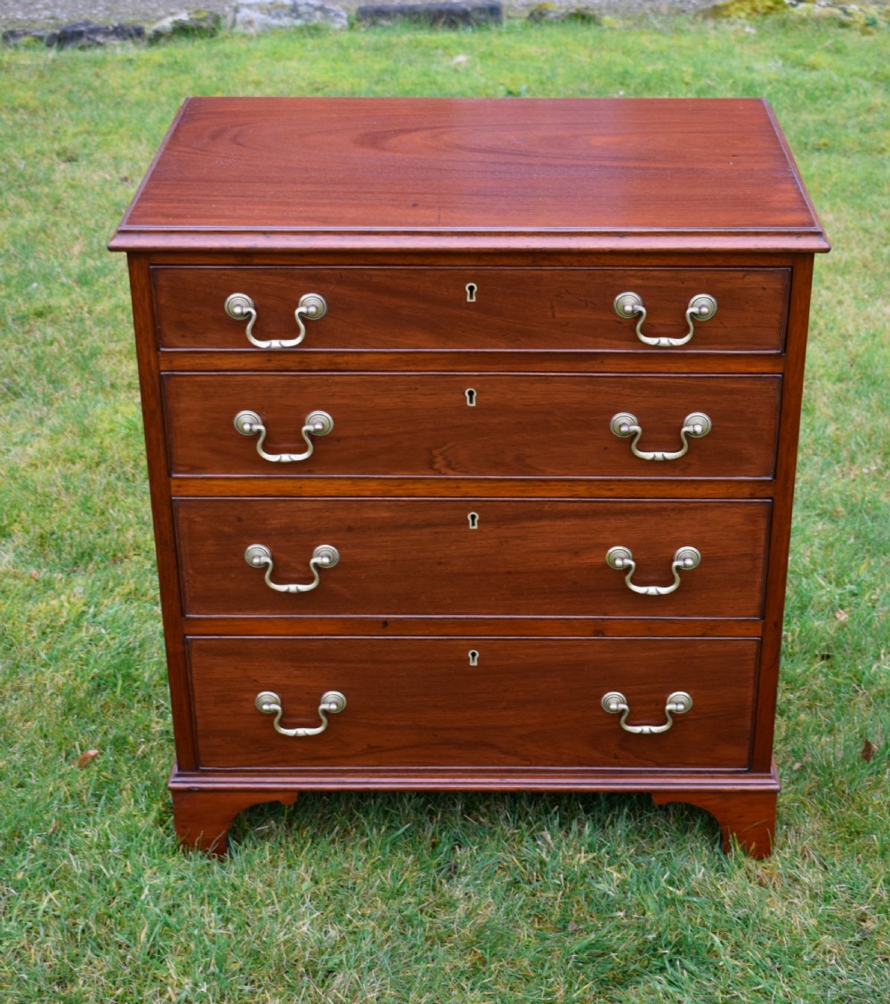 A mahogany chest of drawers featuring four graduated drawers with brass swan-neck handles and bracket feet. View II