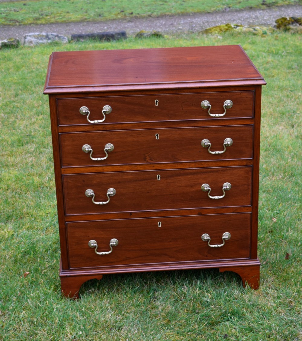 A mahogany chest of drawers featuring four graduated drawers with brass swan-neck handles and bracket feet. View III