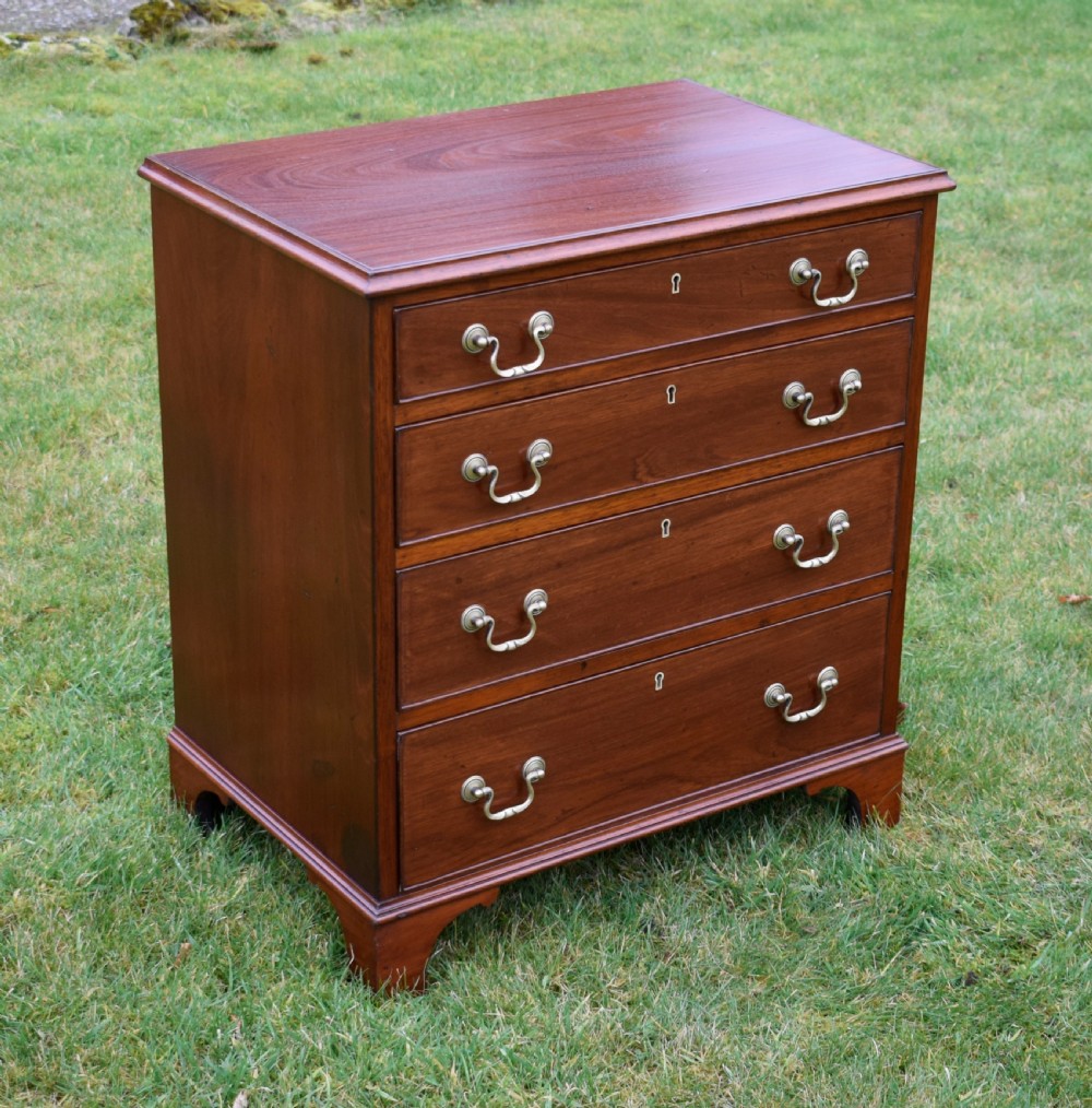 A mahogany chest of drawers featuring four graduated drawers with brass swan-neck handles and bracket feet. View IV