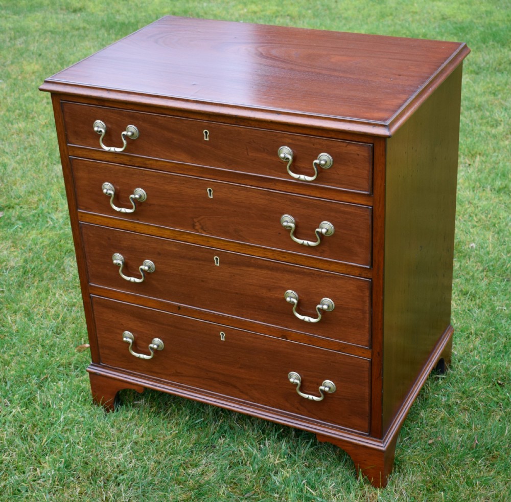 A mahogany chest of drawers featuring four graduated drawers with brass swan-neck handles and bracket feet. View VI