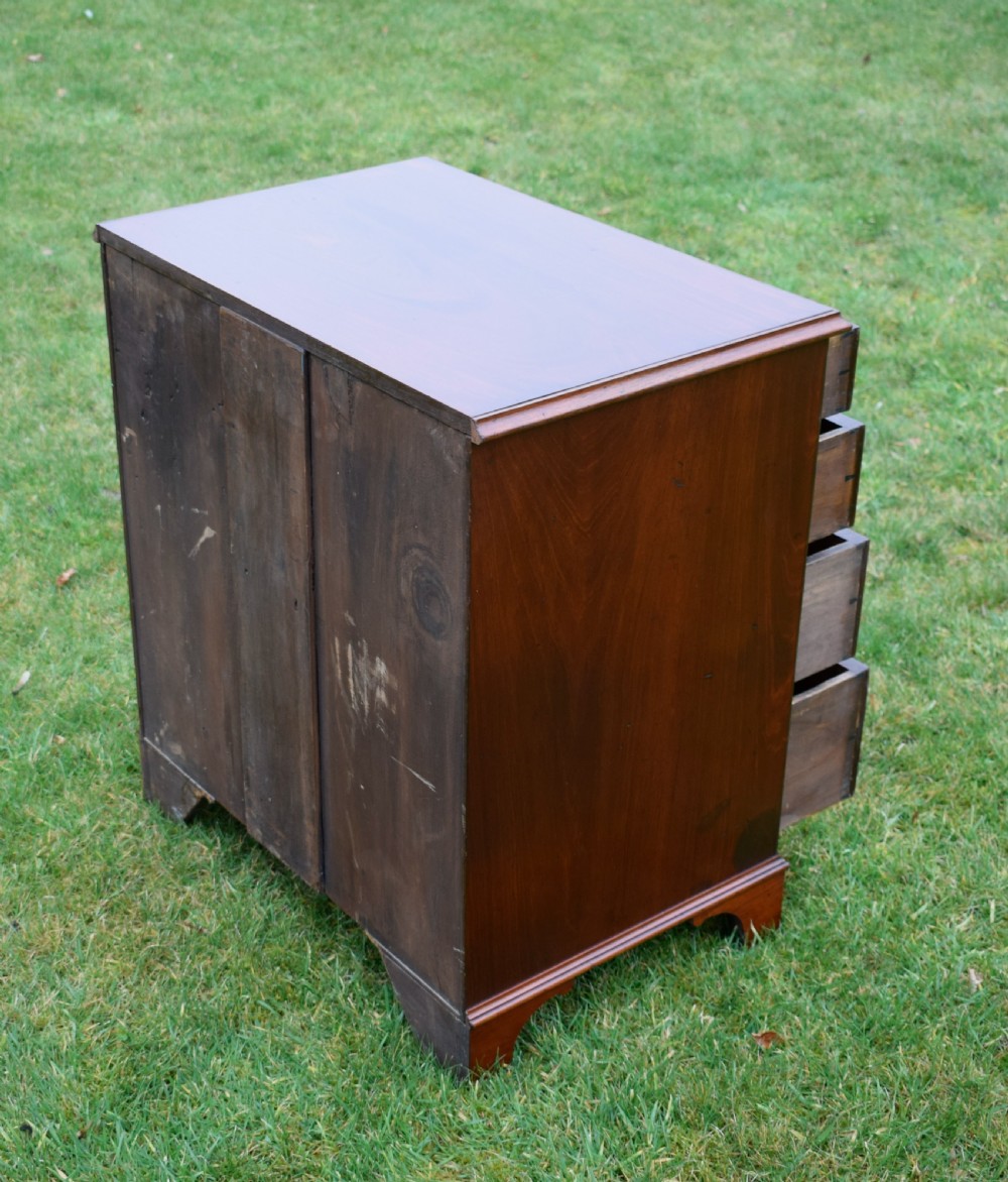 A mahogany chest of drawers featuring four graduated drawers with brass swan-neck handles and bracket feet. View IX