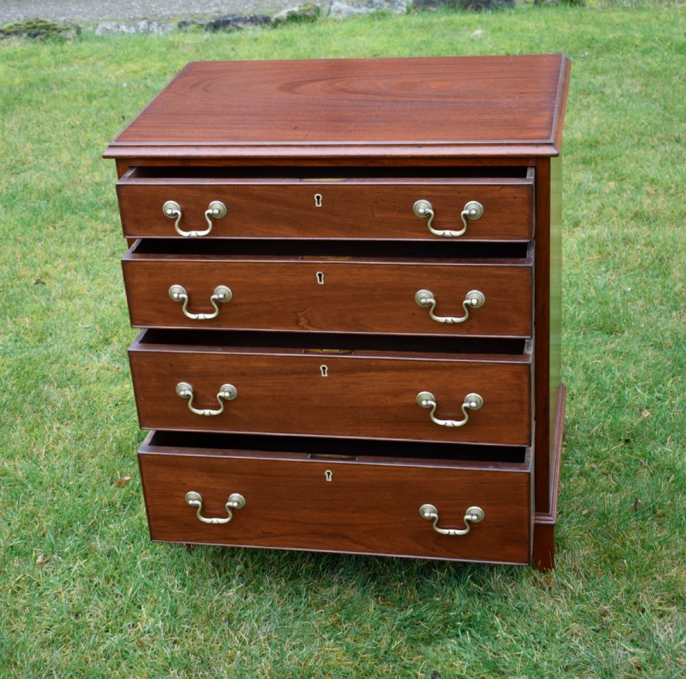 A mahogany chest of drawers featuring four graduated drawers with brass swan-neck handles and bracket feet. View XI