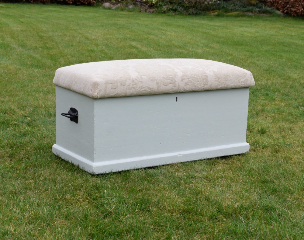 A Victorian painted pine blanket box featuring a cream upholstered cushioned top and iron drop side handles. View III