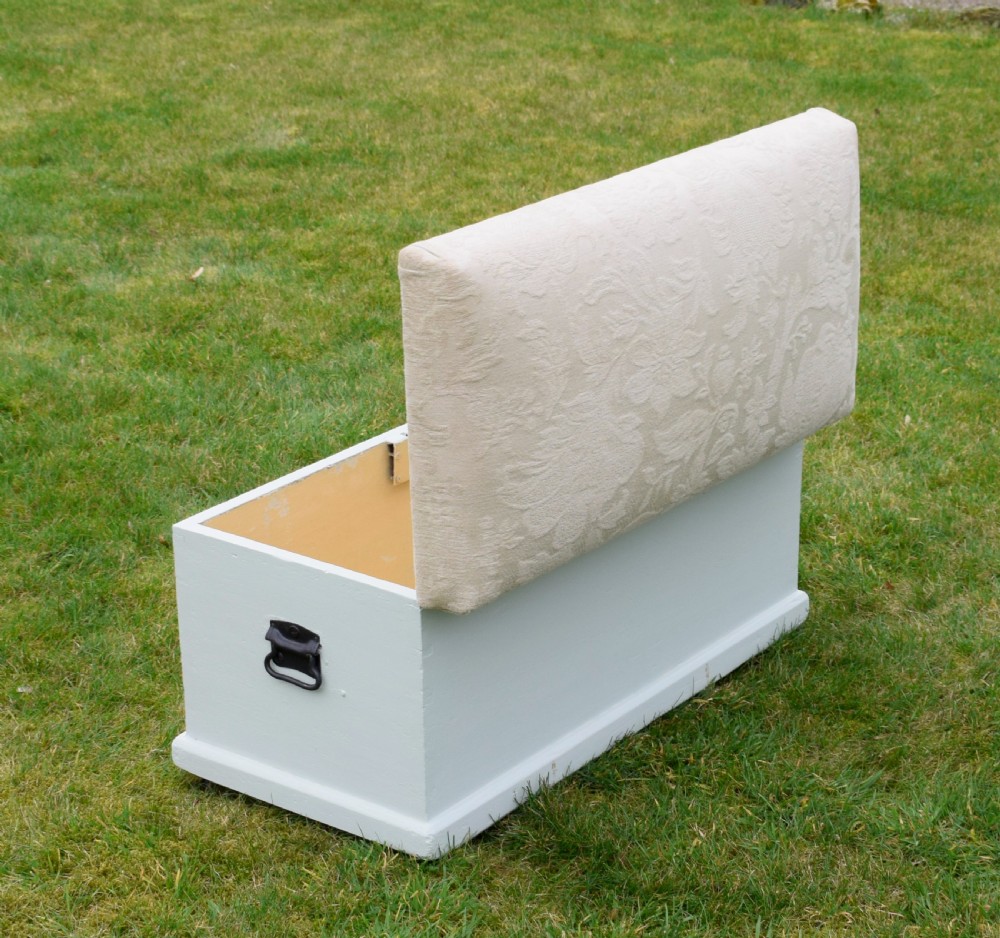 A Victorian painted pine blanket box featuring a cream upholstered cushioned top and iron drop side handles. View XI