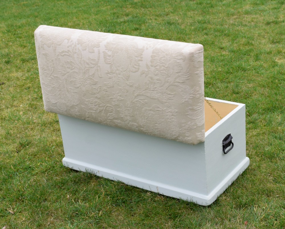 A Victorian painted pine blanket box featuring a cream upholstered cushioned top and iron drop side handles. View XII
