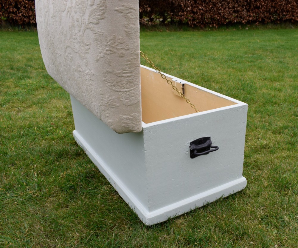 A Victorian painted pine blanket box featuring a cream upholstered cushioned top and iron drop side handles. View XIV
