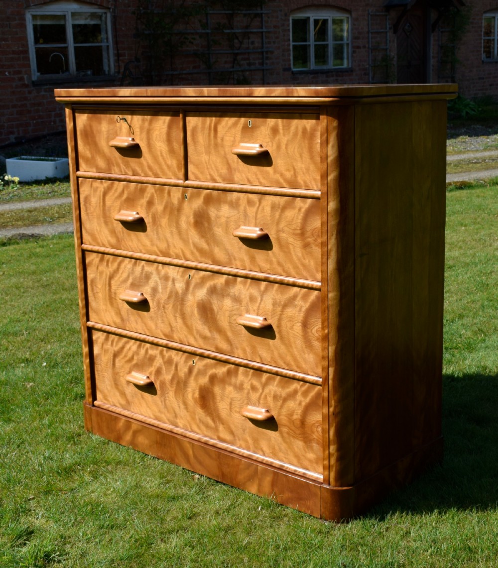 Victorian golden birch chest of drawers featuring a two-over-three drawer configuration, rounded corners, integrated timber handles, and a plinth base. View IV