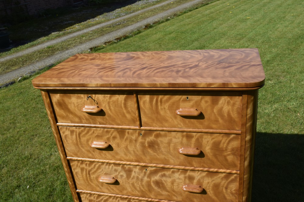 Victorian golden birch chest of drawers featuring a two-over-three drawer configuration, rounded corners, integrated timber handles, and a plinth base. View IX