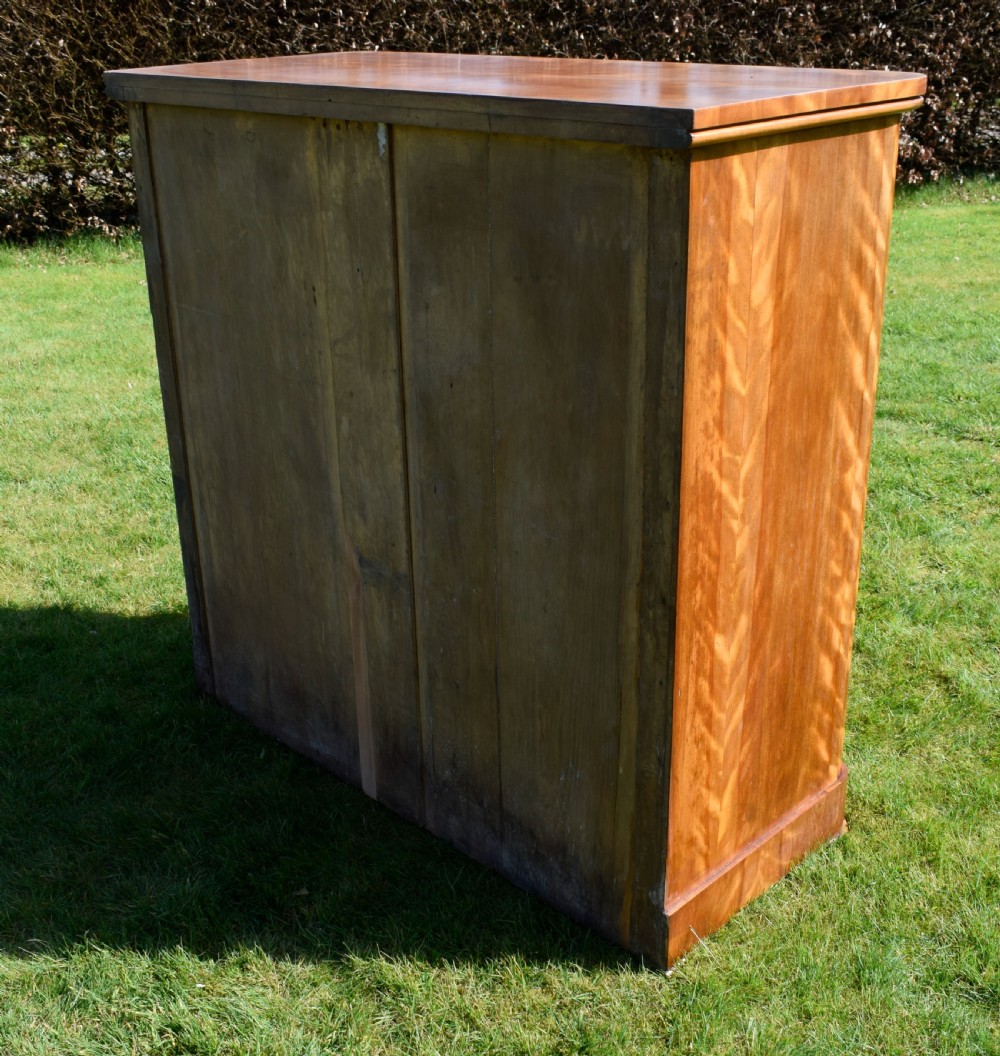 Victorian golden birch chest of drawers featuring a two-over-three drawer configuration, rounded corners, integrated timber handles, and a plinth base. View X