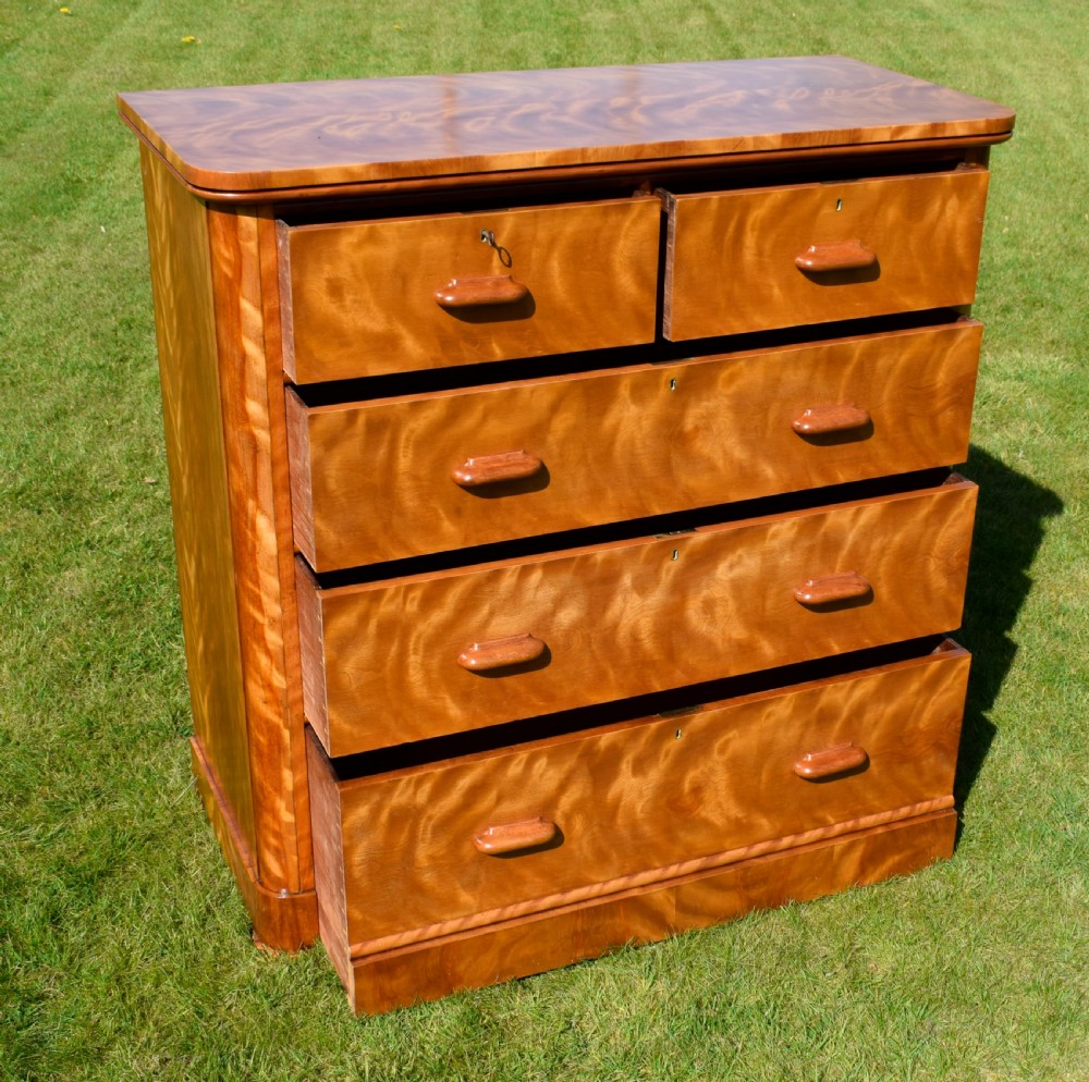 Victorian golden birch chest of drawers featuring a two-over-three drawer configuration, rounded corners, integrated timber handles, and a plinth base. View XII