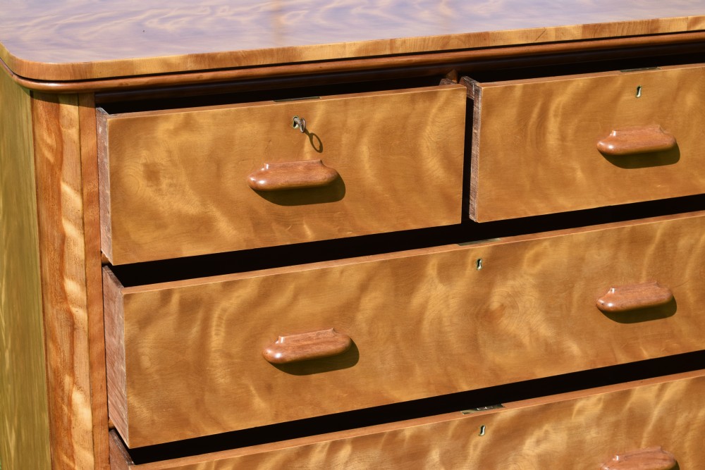 Victorian golden birch chest of drawers featuring a two-over-three drawer configuration, rounded corners, integrated timber handles, and a plinth base. View XIII