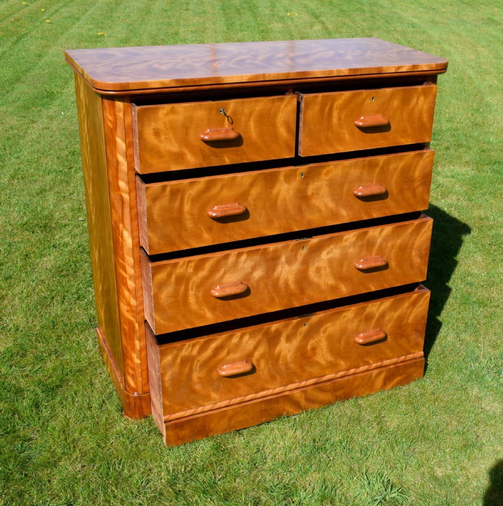 Victorian golden birch chest of drawers featuring a two-over-three drawer configuration, rounded corners, integrated timber handles, and a plinth base. View XV