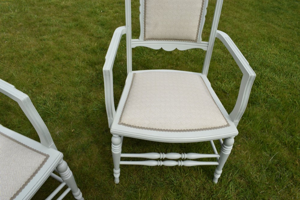 A pair of painted pale green Edwardian open armchairs featuring cream upholstered seats, padded backrest panels, turned front legs, and scalloped top rails. View VII