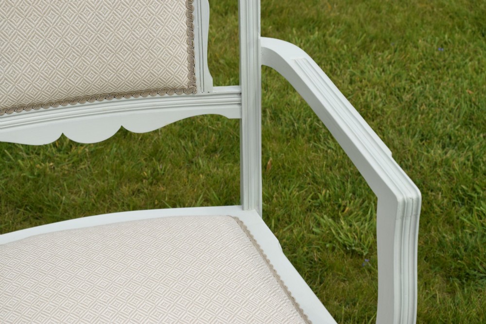 A pair of painted pale green Edwardian open armchairs featuring cream upholstered seats, padded backrest panels, turned front legs, and scalloped top rails. View VIII