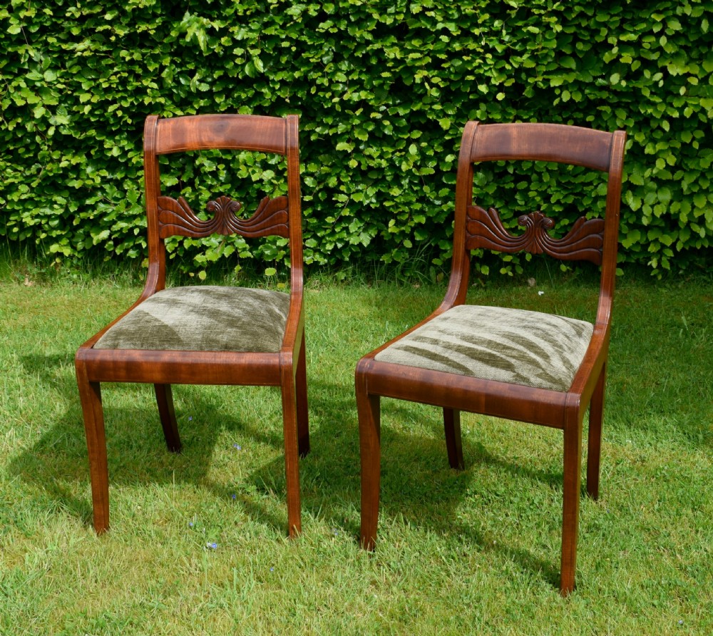 A pair of mahogany side chairs with curved tablet top rails, carved back splats, and green patterned upholstered seats. View II