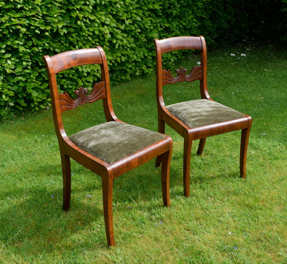 A pair of mahogany side chairs with curved tablet top rails, carved back splats, and green patterned upholstered seats. View III
