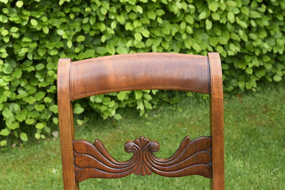 A pair of mahogany side chairs with curved tablet top rails, carved back splats, and green patterned upholstered seats. View IV