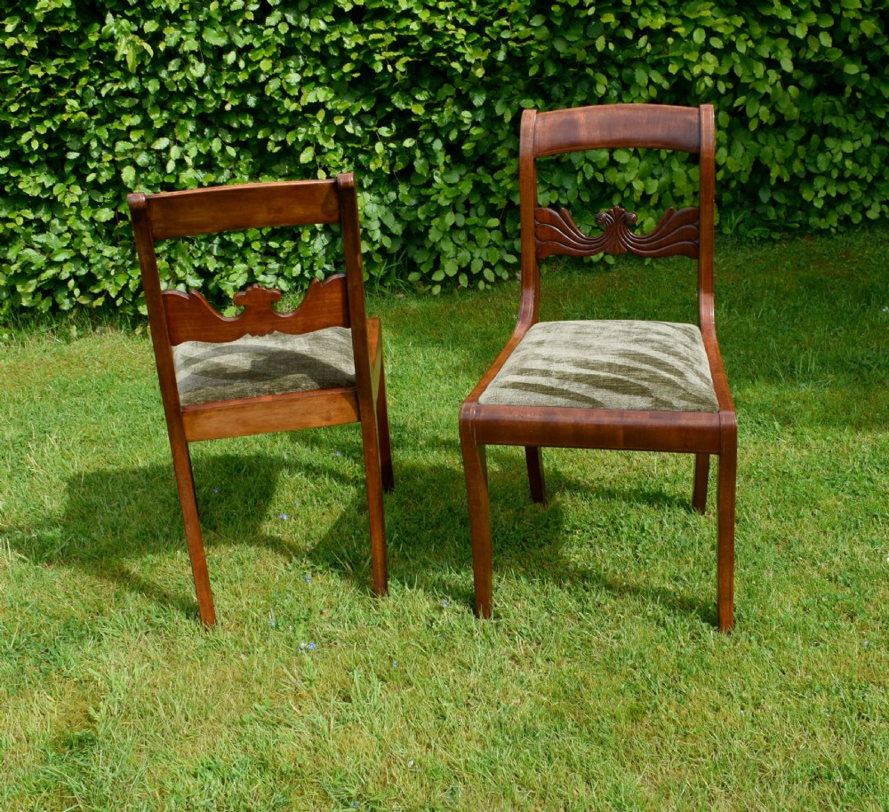 A pair of mahogany side chairs with curved tablet top rails, carved back splats, and green patterned upholstered seats. View VII