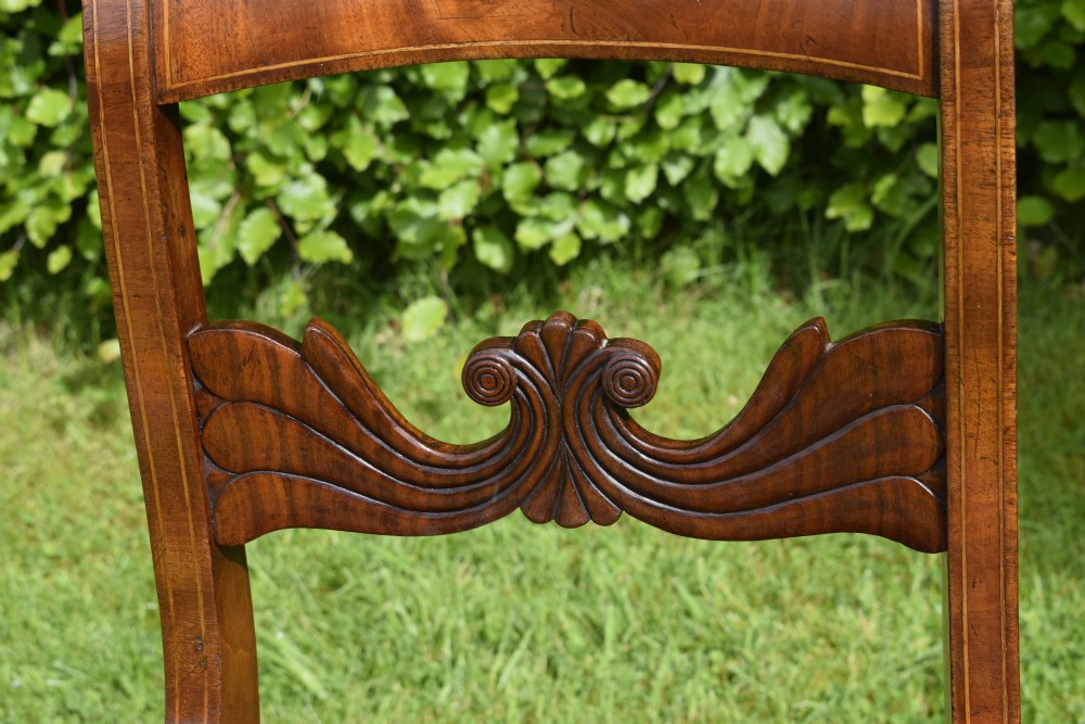 A pair of mahogany side chairs with curved tablet top rails, carved back splats, and green patterned upholstered seats. View IX