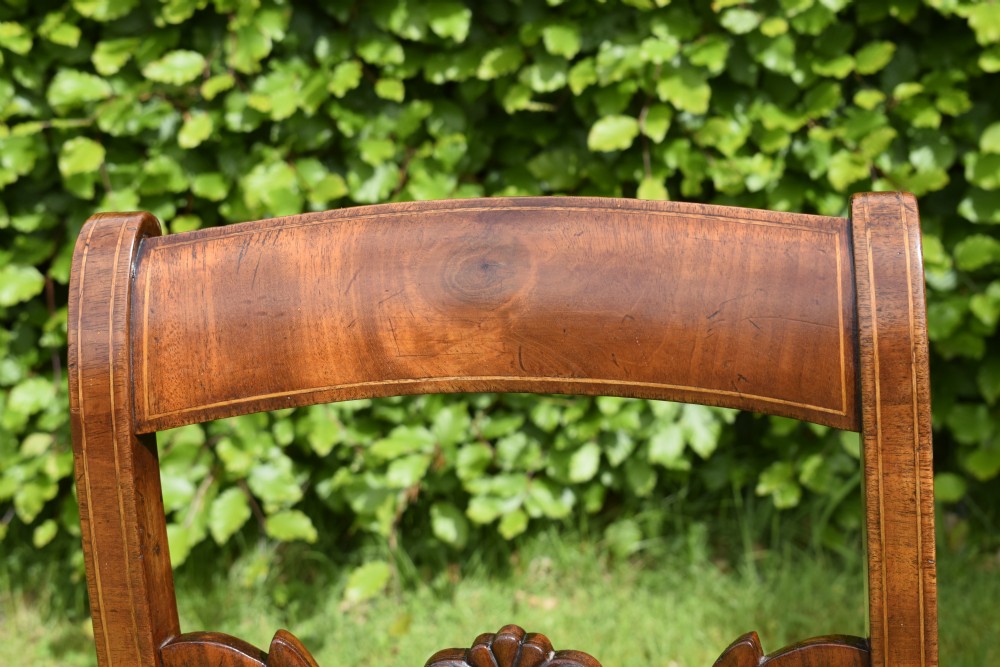 A pair of mahogany side chairs with curved tablet top rails, carved back splats, and green patterned upholstered seats. View X