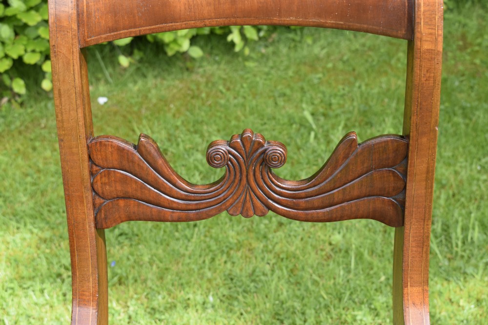 A pair of mahogany side chairs with curved tablet top rails, carved back splats, and green patterned upholstered seats. View XI