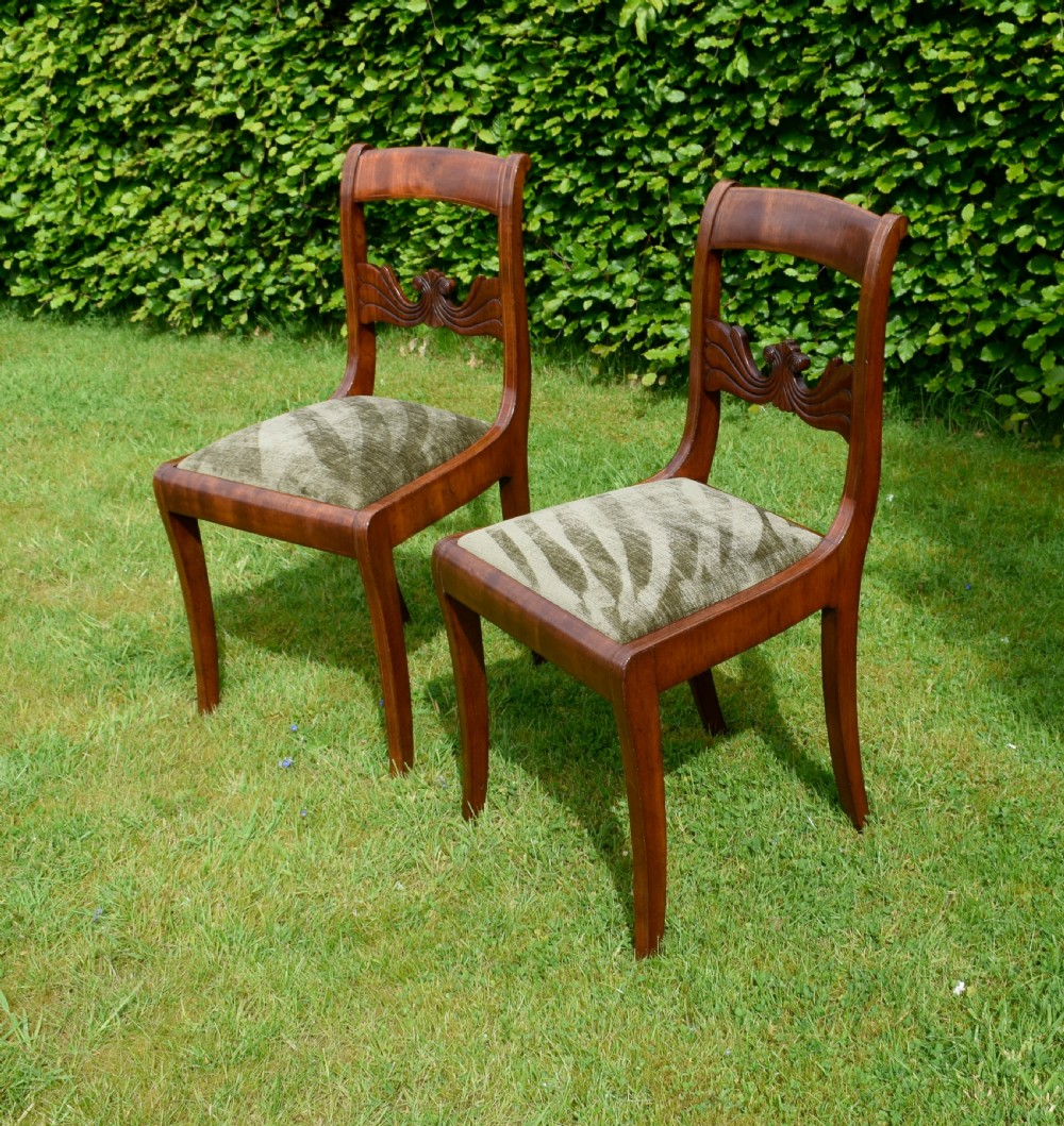 A pair of mahogany side chairs with curved tablet top rails, carved back splats, and green patterned upholstered seats. View XIV