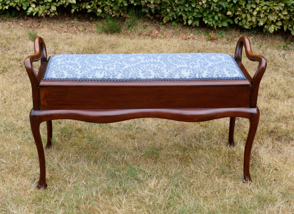 A mahogany duet piano stool with a blue patterned upholstered seat and carved cabriole legs. View III