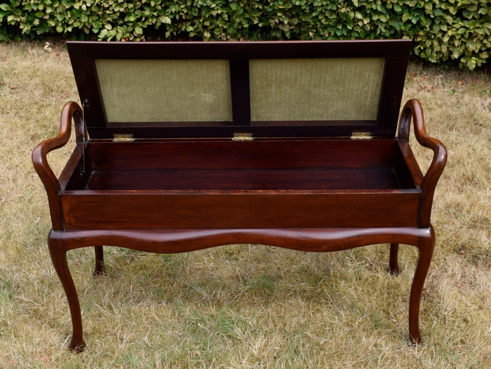 A mahogany duet piano stool with a blue patterned upholstered seat and carved cabriole legs. View XI