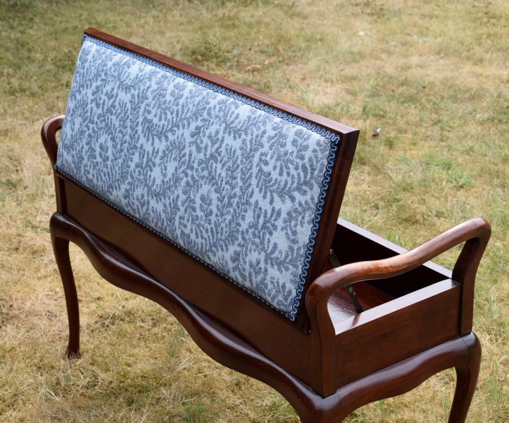 A mahogany duet piano stool with a blue patterned upholstered seat and carved cabriole legs. View XII