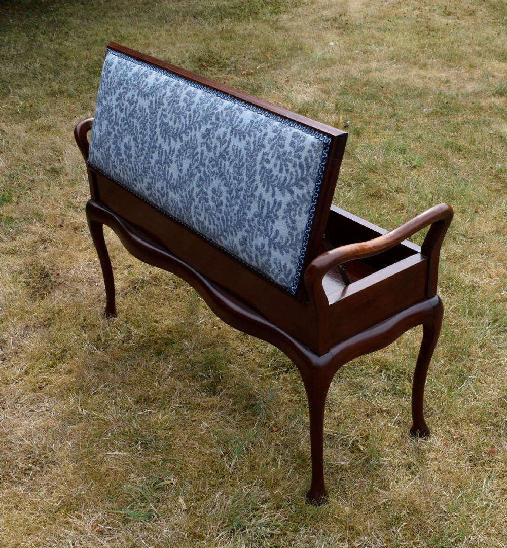 A mahogany duet piano stool with a blue patterned upholstered seat and carved cabriole legs. View XIII