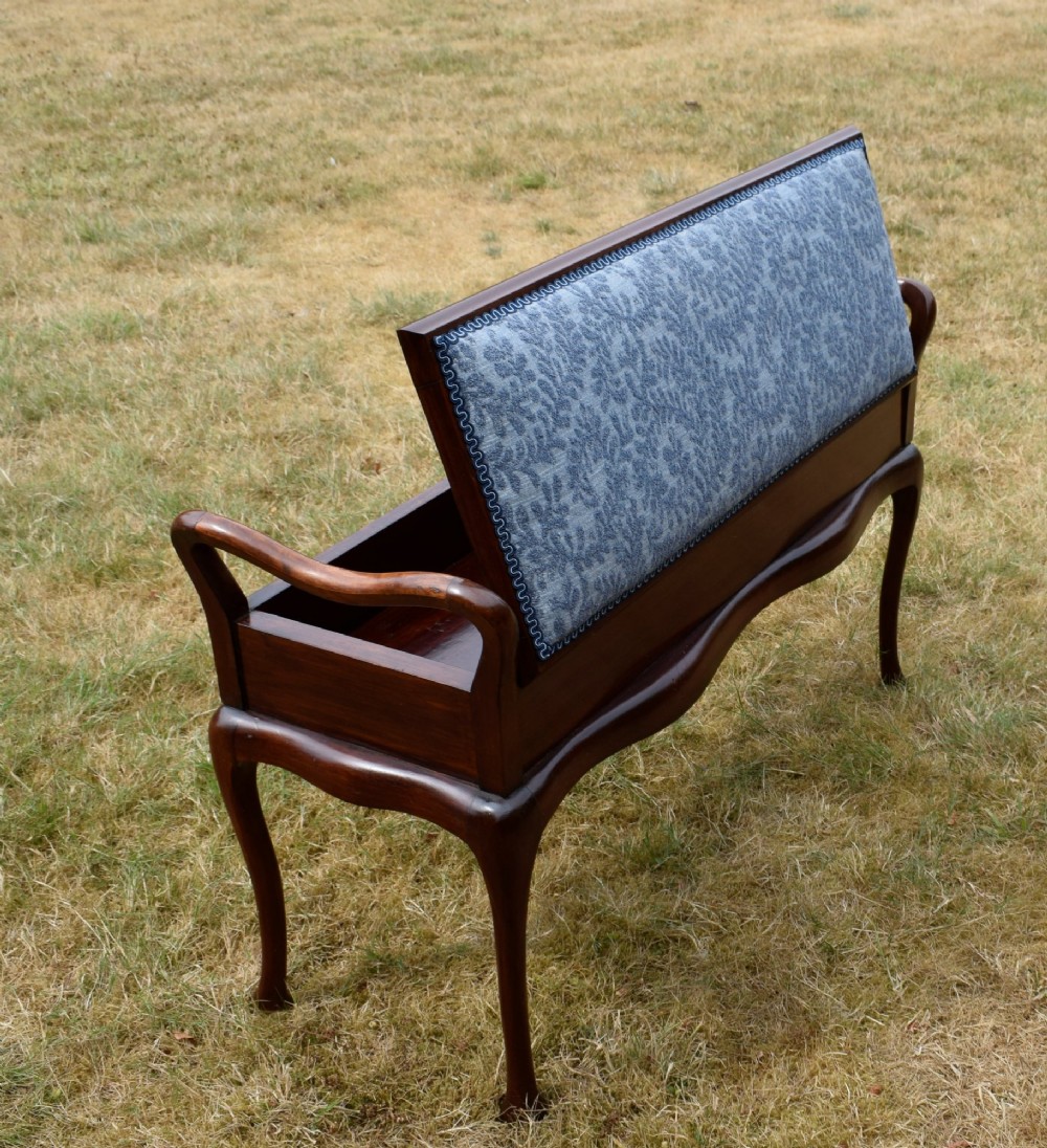 A mahogany duet piano stool with a blue patterned upholstered seat and carved cabriole legs. View XIV