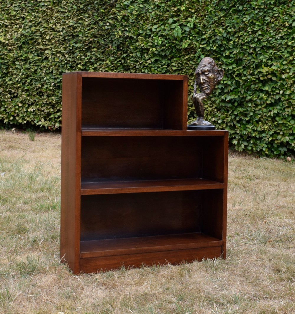 A dark brown wooden Art Deco bookcase featuring an asymmetrical stepped design with three open shelves. View III