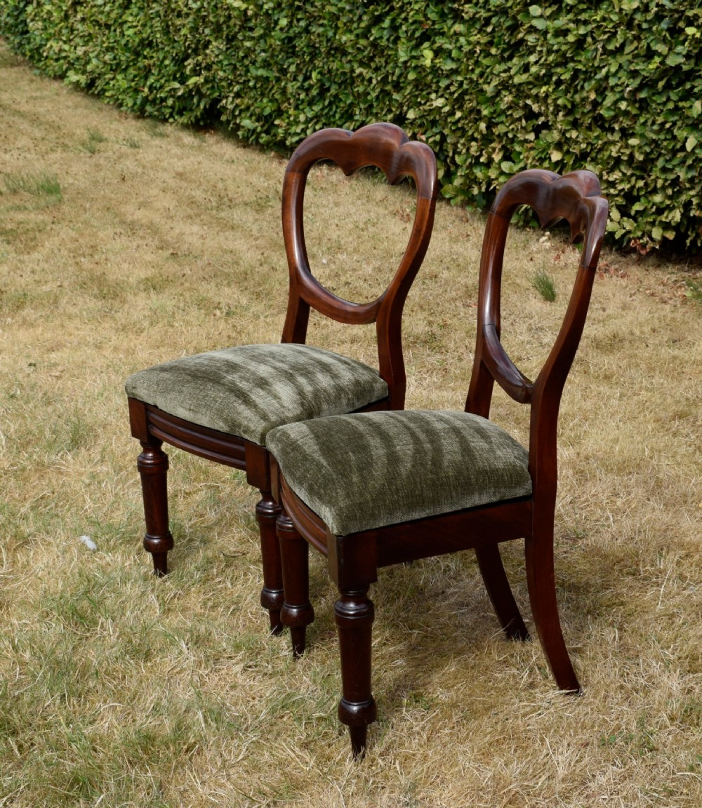 A pair of Victorian mahogany crown back dining chairs with green velvet upholstered seats and turned front legs. View III