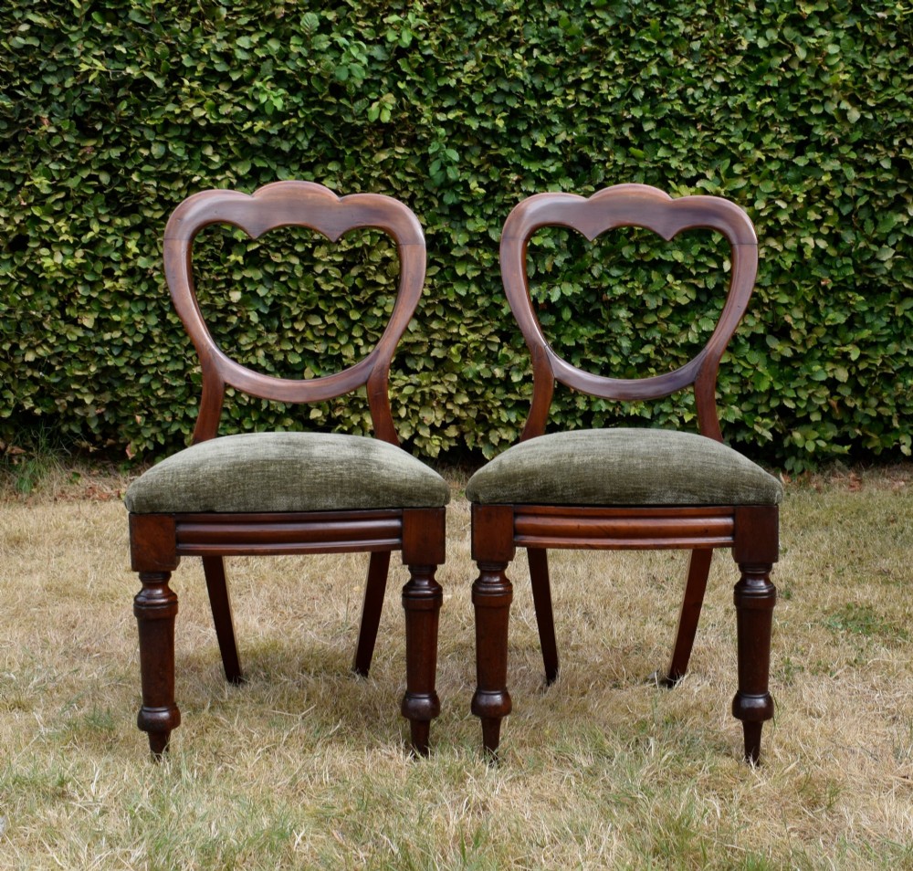 A pair of Victorian mahogany crown back dining chairs with green velvet upholstered seats and turned front legs. View IX
