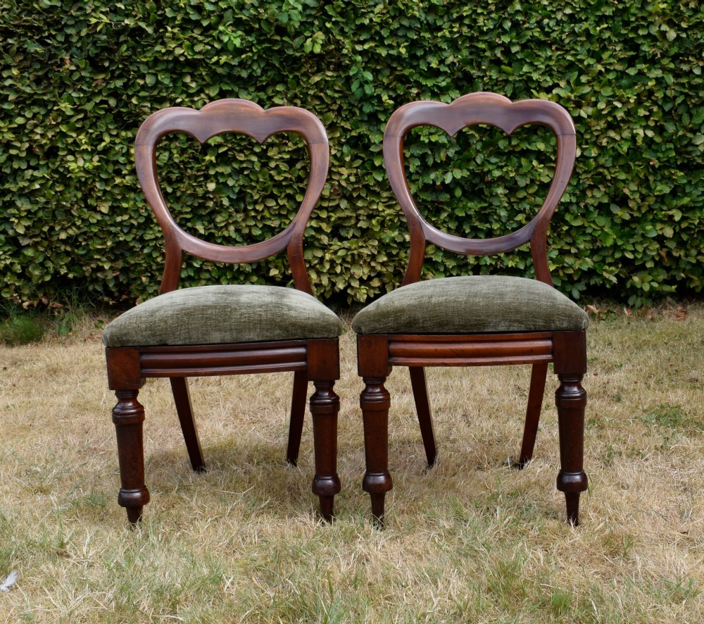 A pair of Victorian mahogany crown back dining chairs with green velvet upholstered seats and turned front legs. View XI
