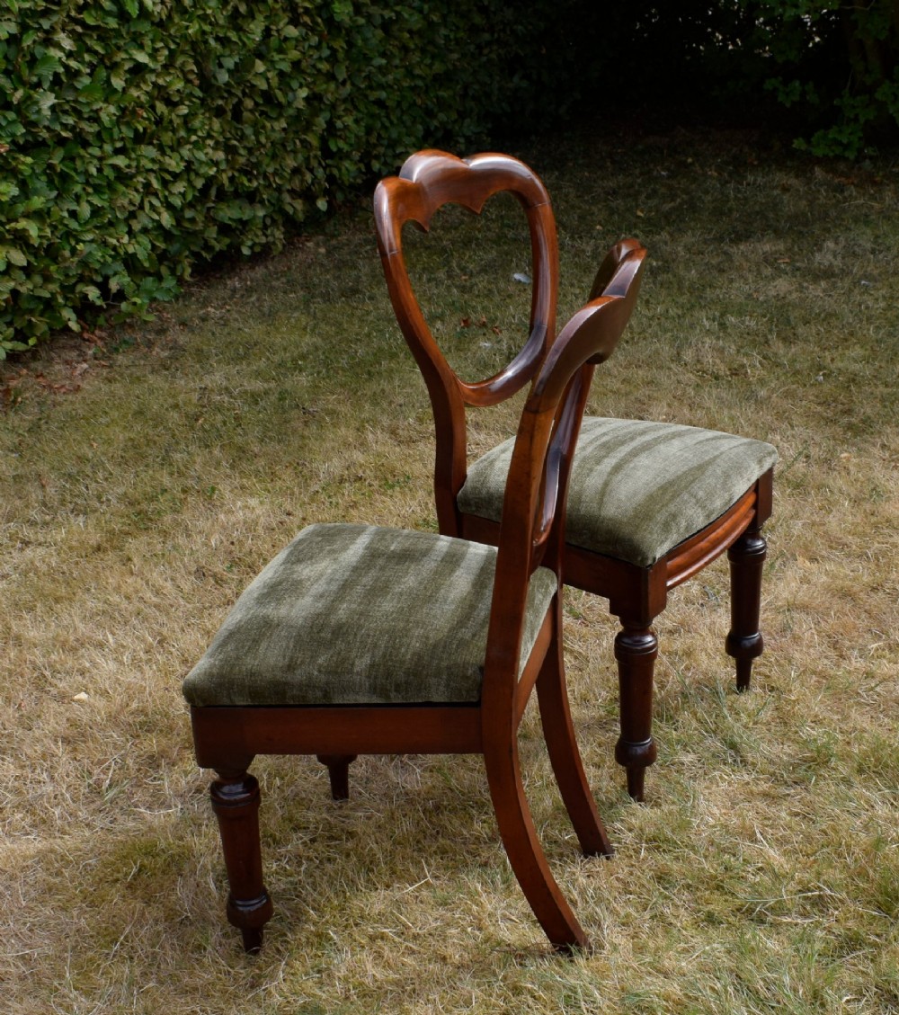 A pair of Victorian mahogany crown back dining chairs with green velvet upholstered seats and turned front legs. View XII