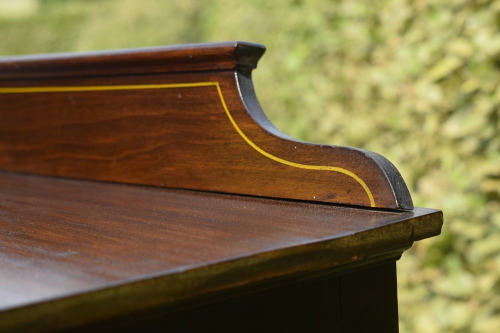 An Edwardian mahogany display cabinet featuring satinwood inlay, a single door with a central diamond astragal glazing bar, glass shelves, and square tapered legs. View VIII