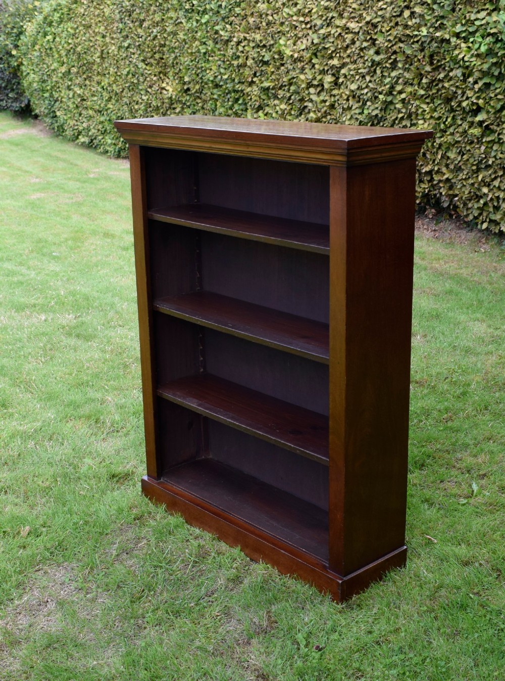 An early 20th-century open-front mahogany bookcase featuring three internal shelves, a moulded top cornice, and a sturdy plinth base. View IV