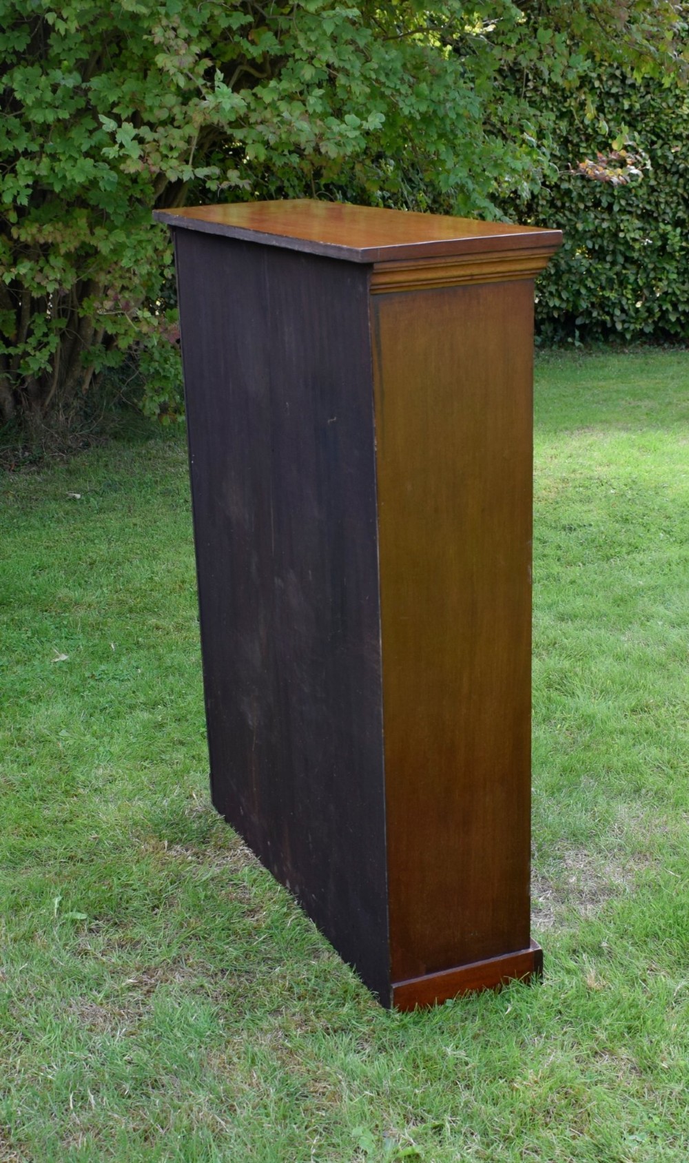 An early 20th-century open-front mahogany bookcase featuring three internal shelves, a moulded top cornice, and a sturdy plinth base. View VII