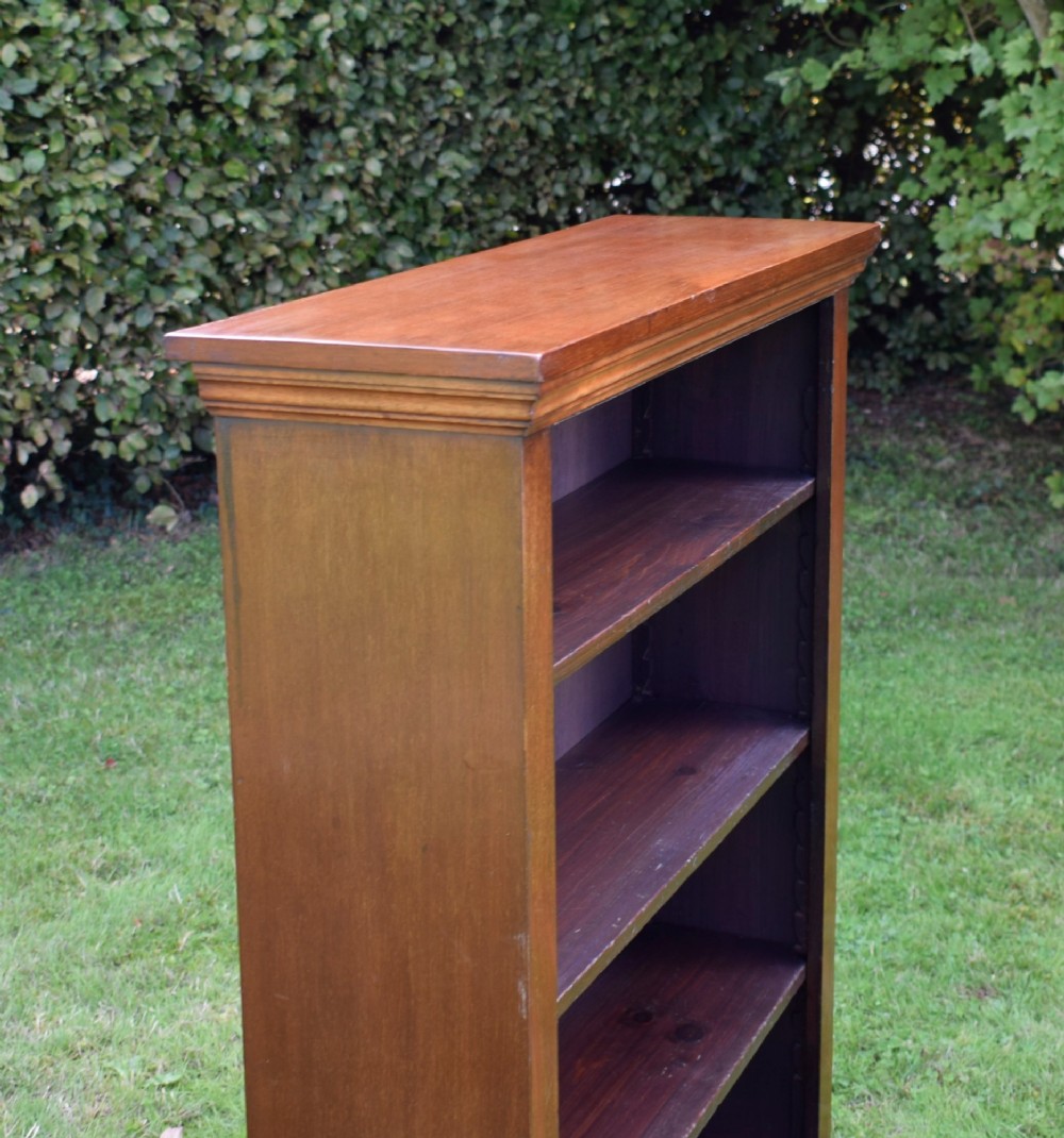 An early 20th-century open-front mahogany bookcase featuring three internal shelves, a moulded top cornice, and a sturdy plinth base. View VIII