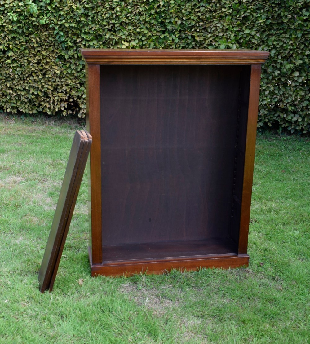 An early 20th-century open-front mahogany bookcase featuring three internal shelves, a moulded top cornice, and a sturdy plinth base. View IX