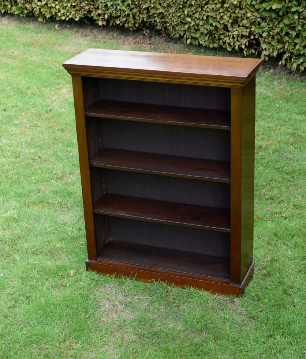 An early 20th-century open-front mahogany bookcase featuring three internal shelves, a moulded top cornice, and a sturdy plinth base. View X