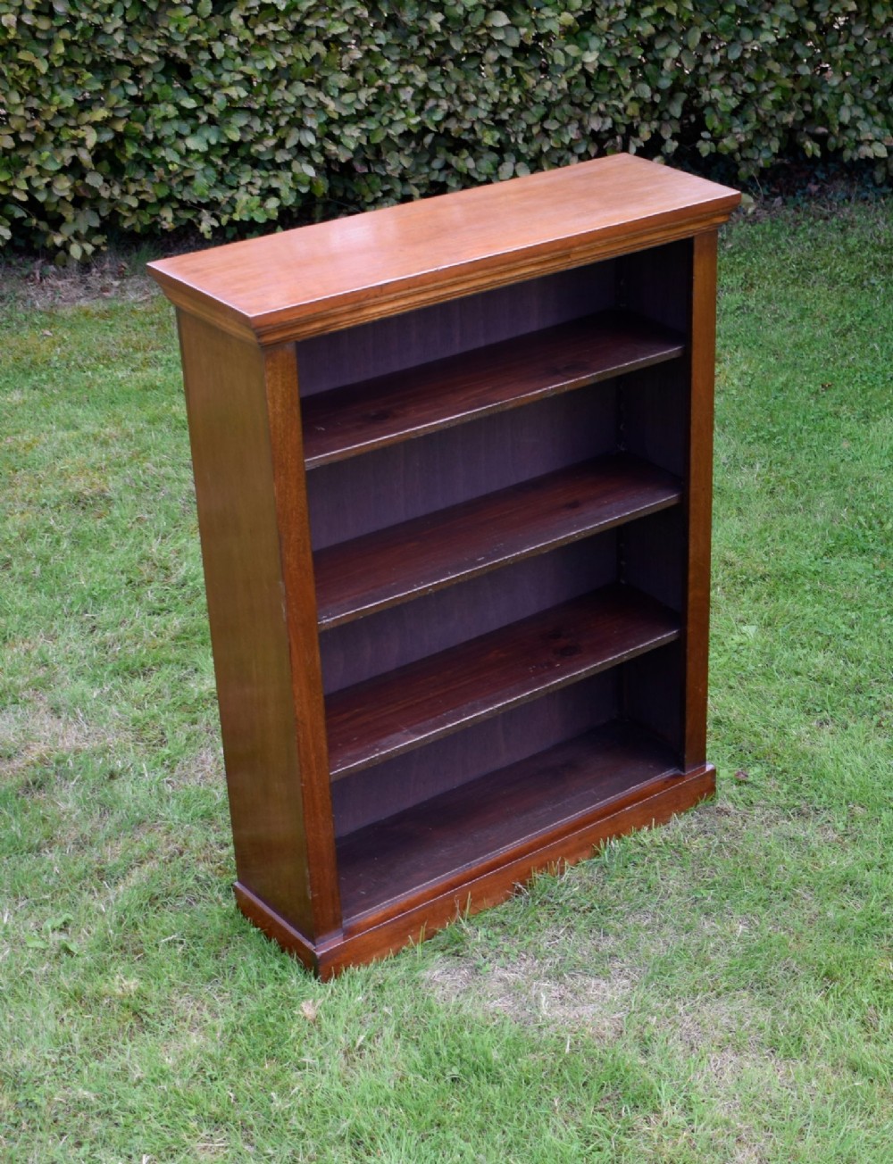 An early 20th-century open-front mahogany bookcase featuring three internal shelves, a moulded top cornice, and a sturdy plinth base. View XI